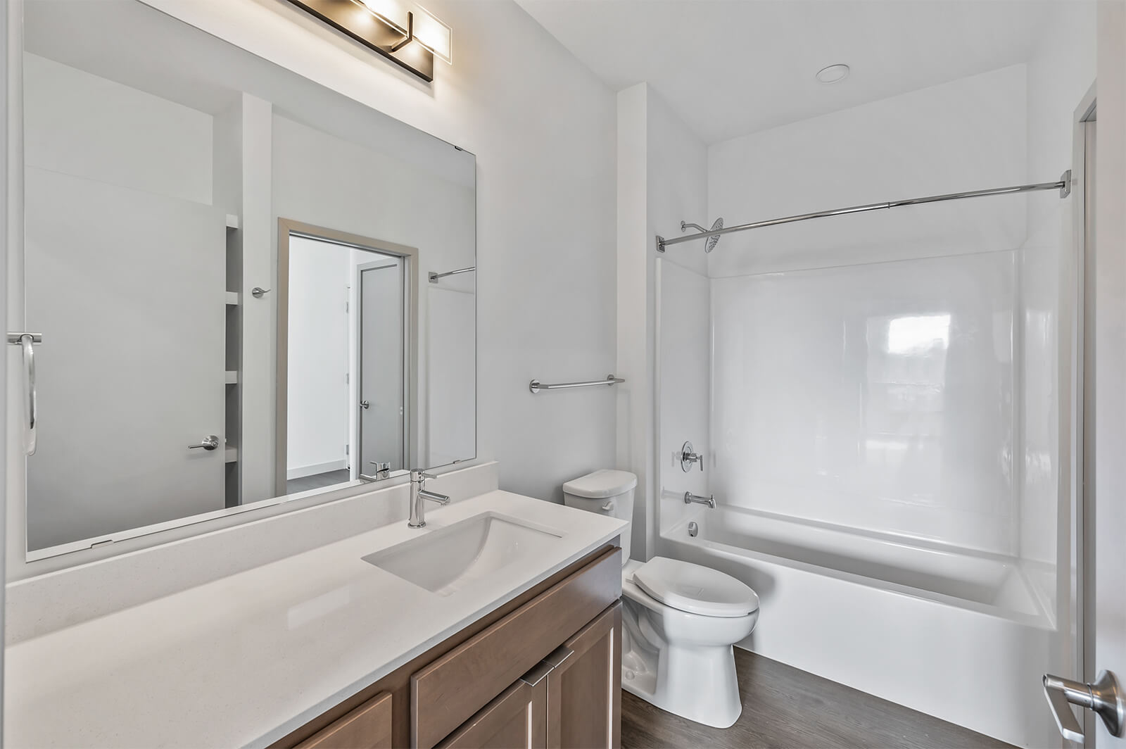 Bathroom with single vanity and bathtub with shower