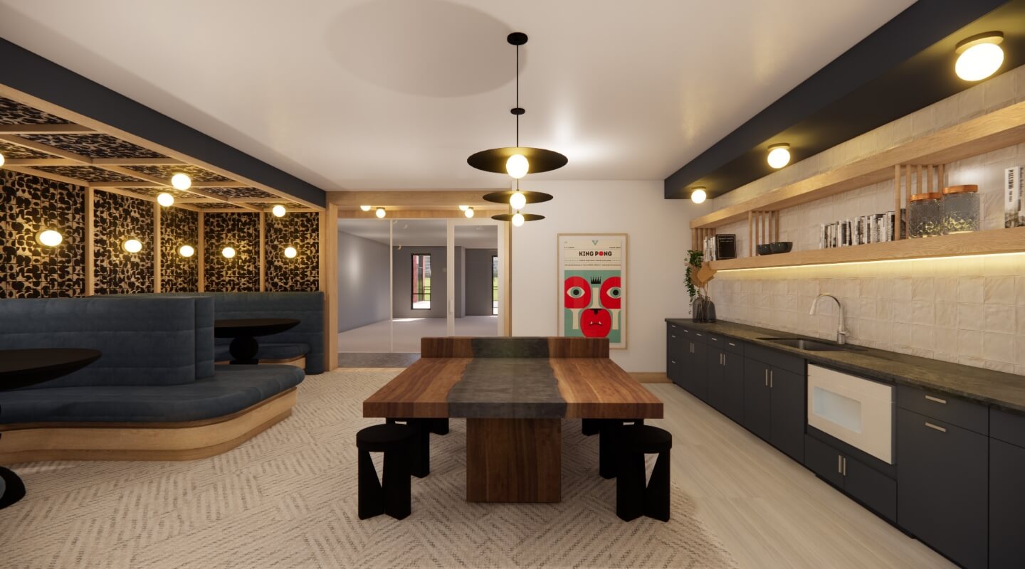 Contemporary dining area with blue curved banquettes, a bold wooden table, artistic lighting, and a chic kitchenette.