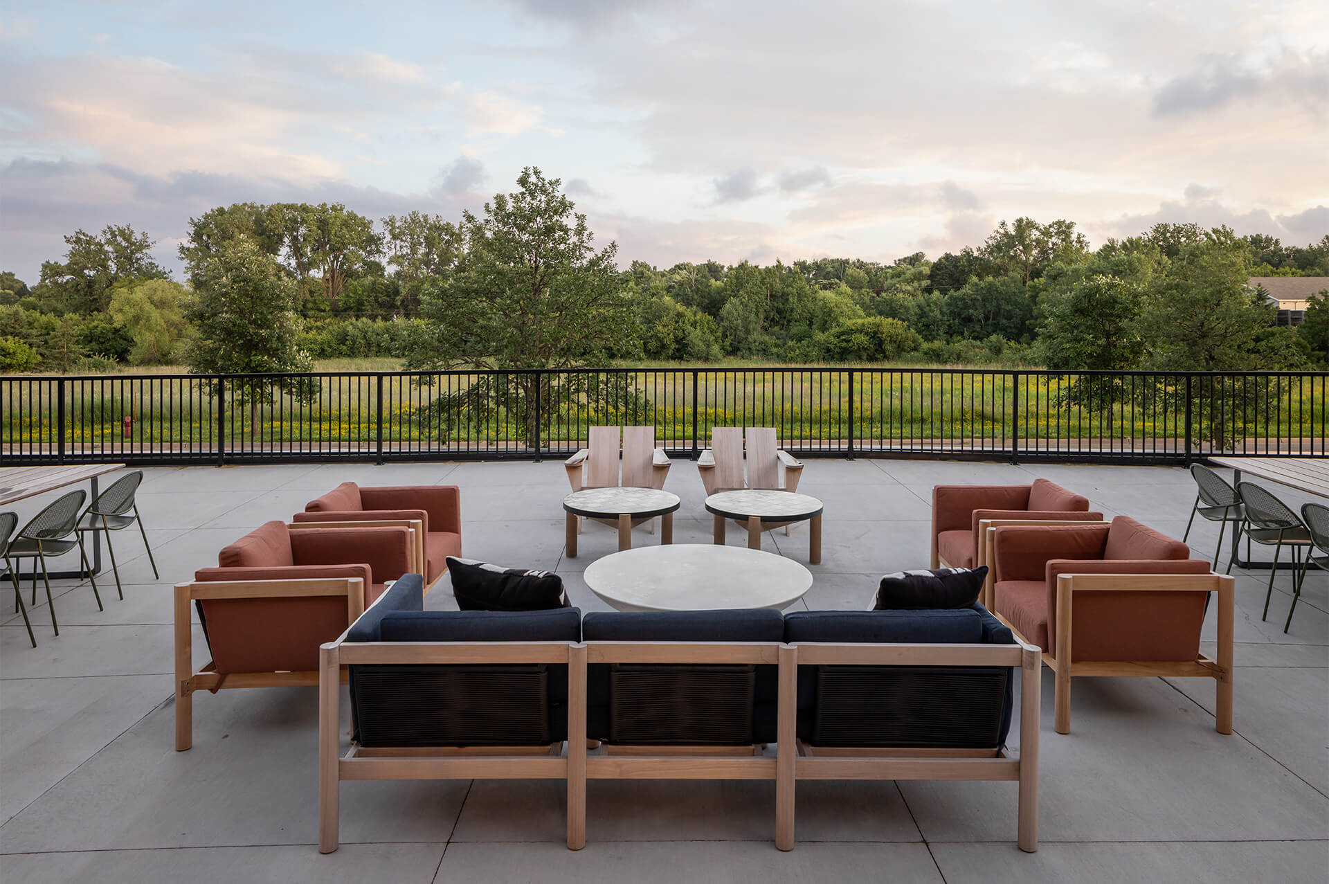 Sunset view of the outdoor lounge area with seating at The Harlan Oakdale
