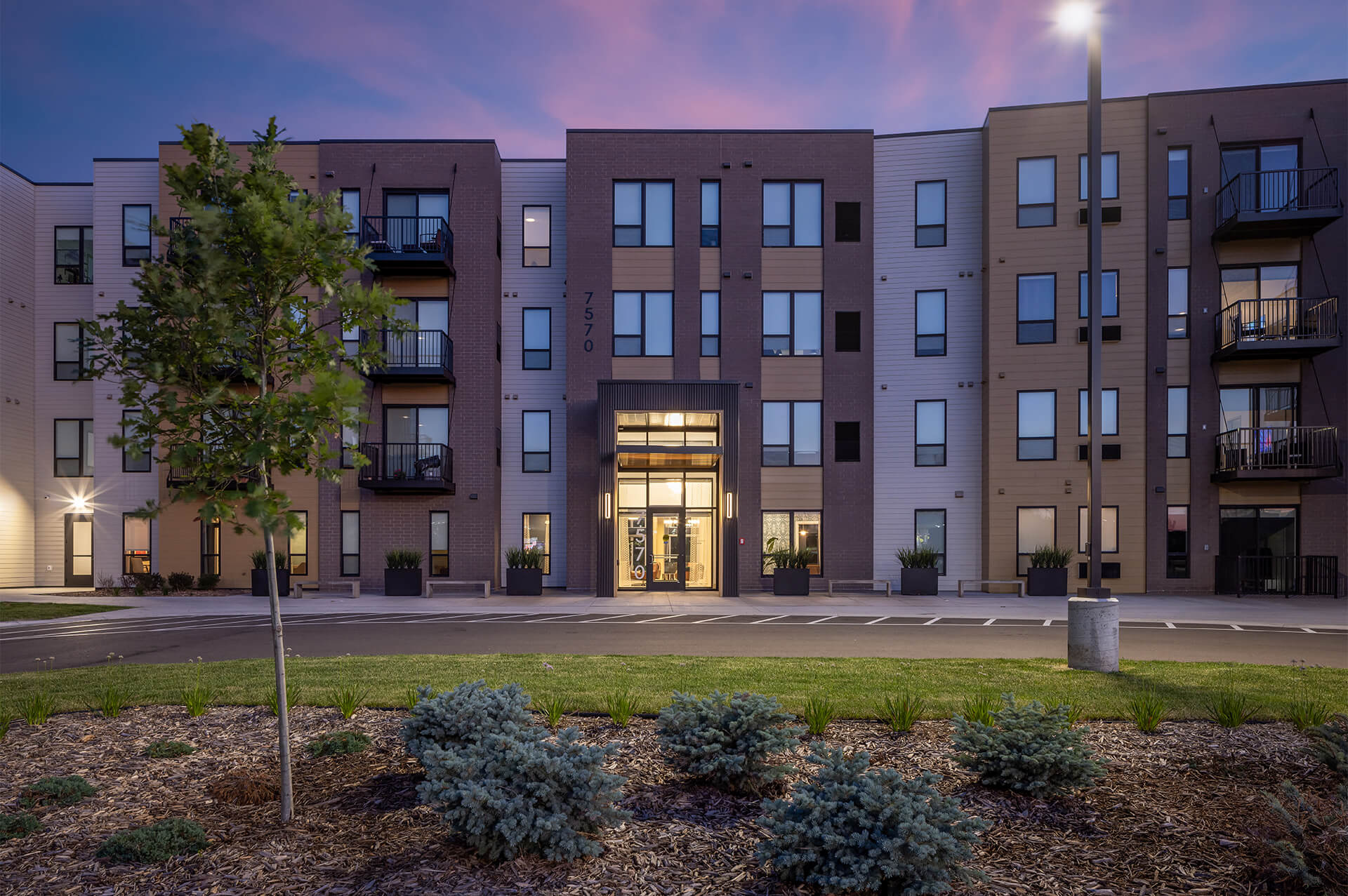 Evening view of the main entrance at The Harlan Oakdale apartments