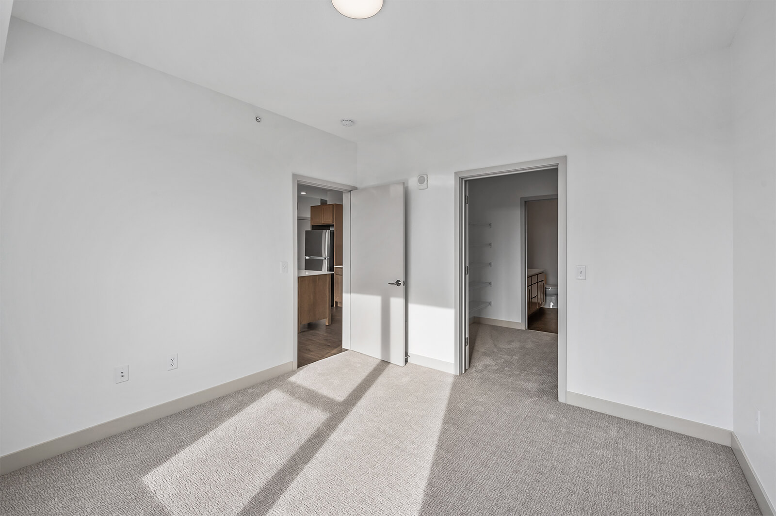 Bedroom with doorway leading to bathroom and closet