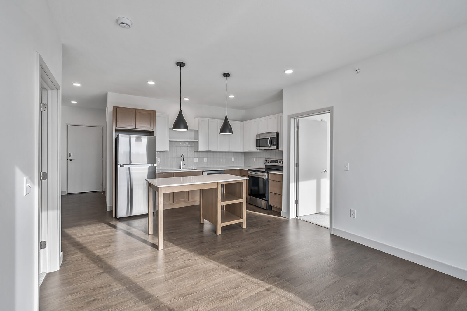 Open kitchen view from living room with pendant lights