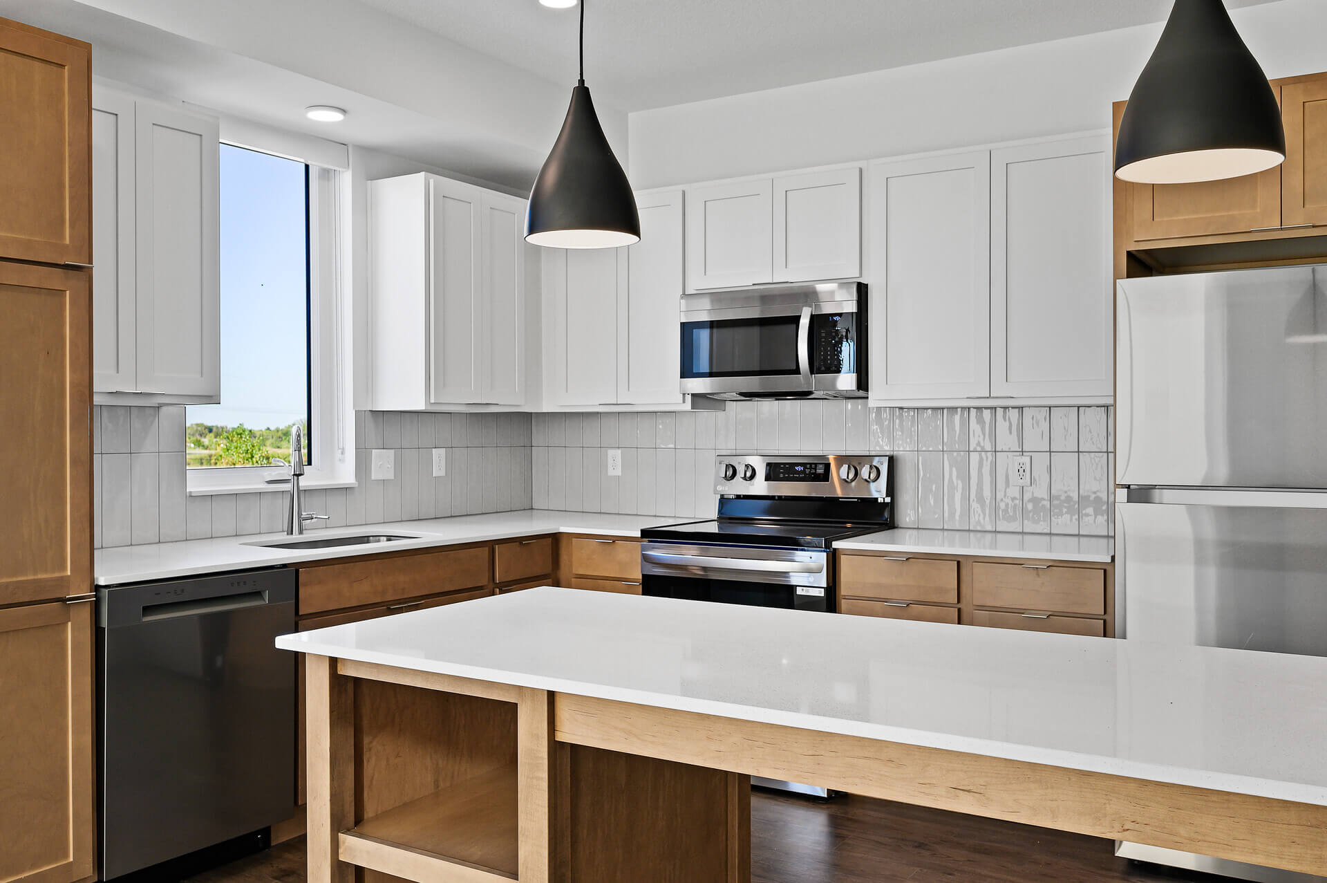 Closeup of kitchen lighting and wood cabinetr