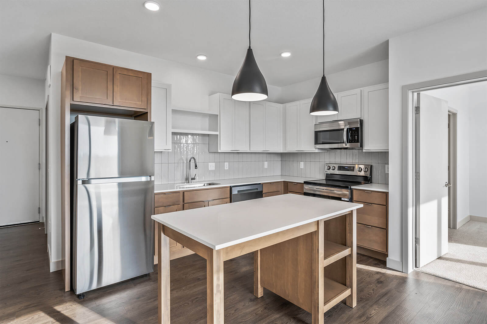 Kitchen with island, pendant lights, and modern appliances