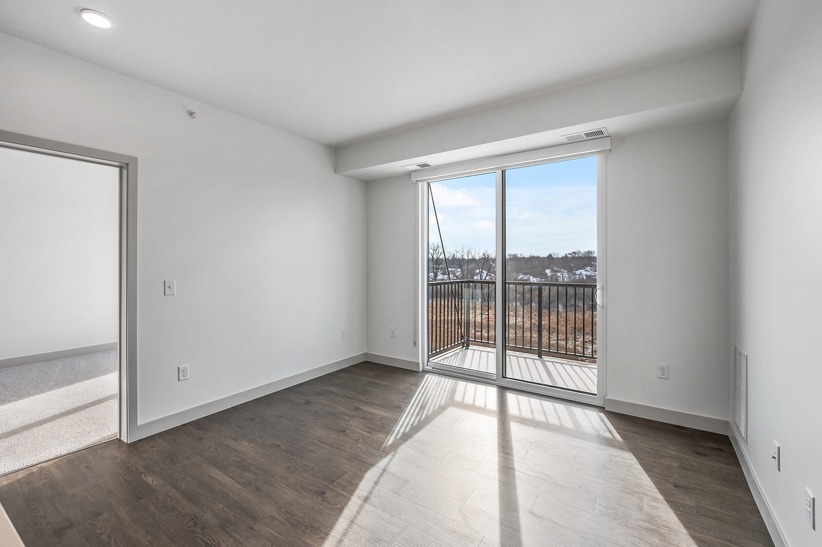 Bright living room with large sliding balcony door