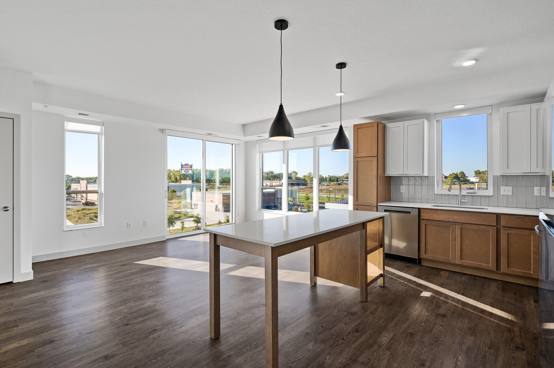 Open kitchen and living area with wood flooring