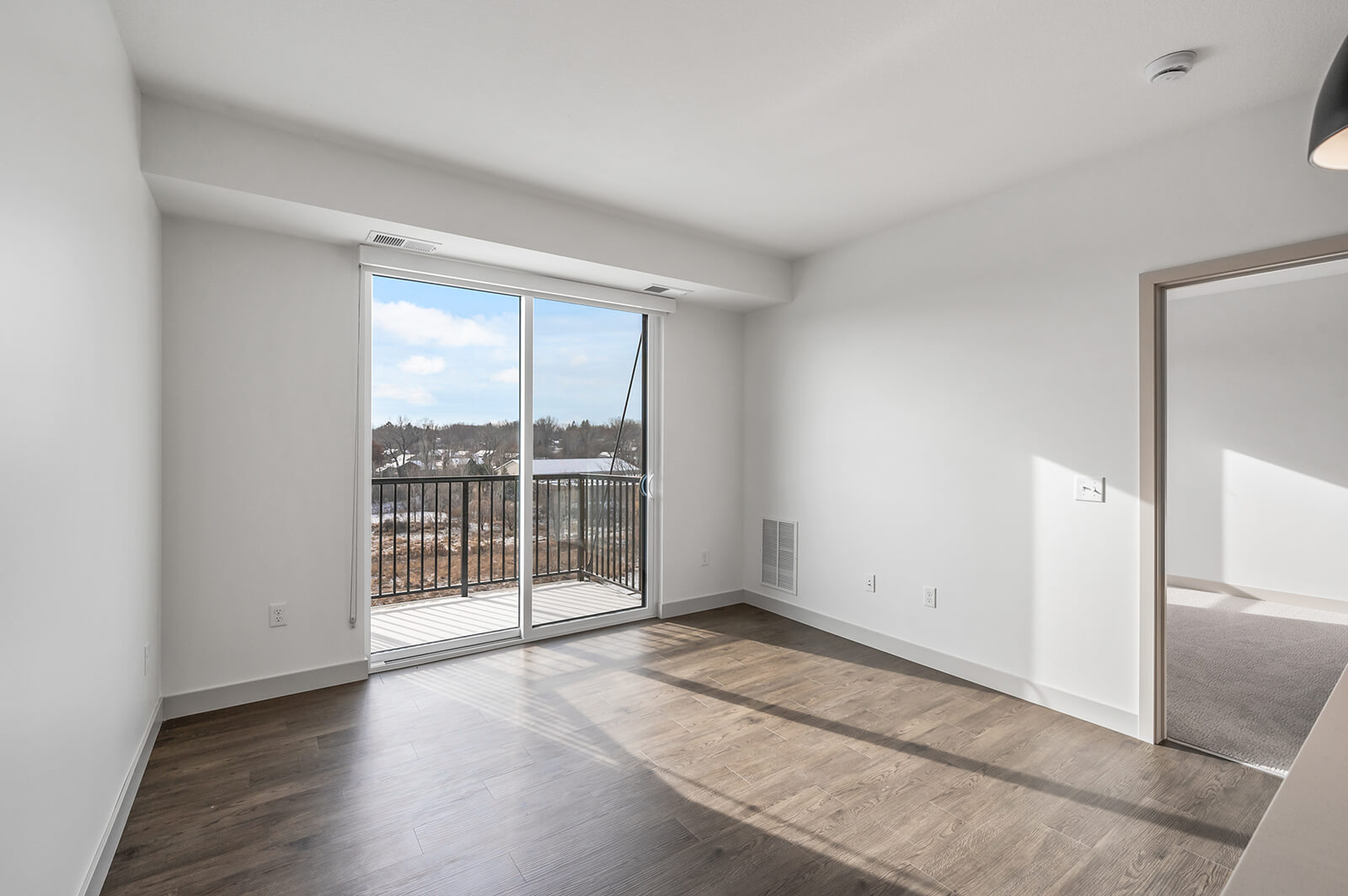 Living room with sliding glass door leading to balcony