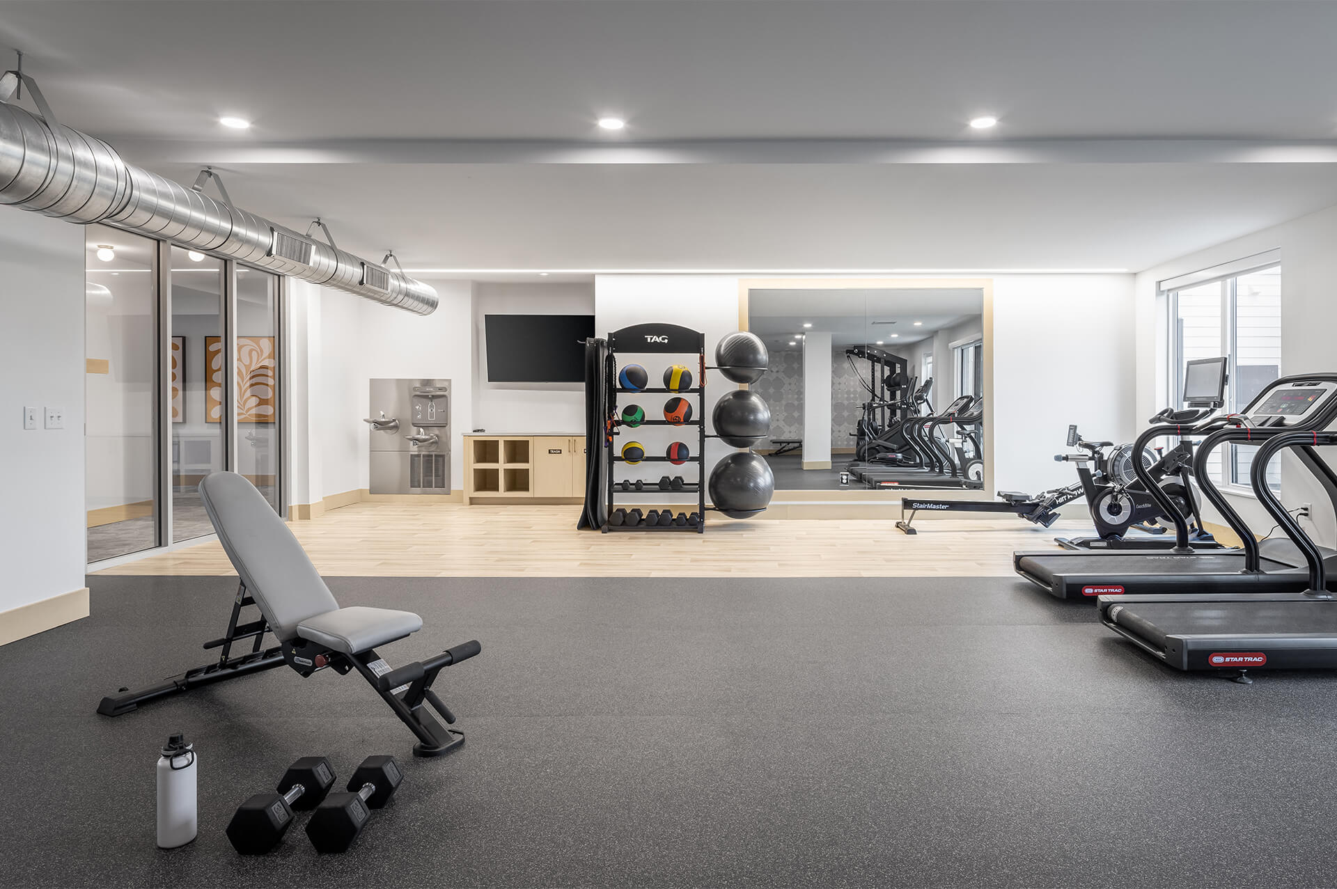Modern fitness center at The Harlan Oakdale with cardio and strength equipment