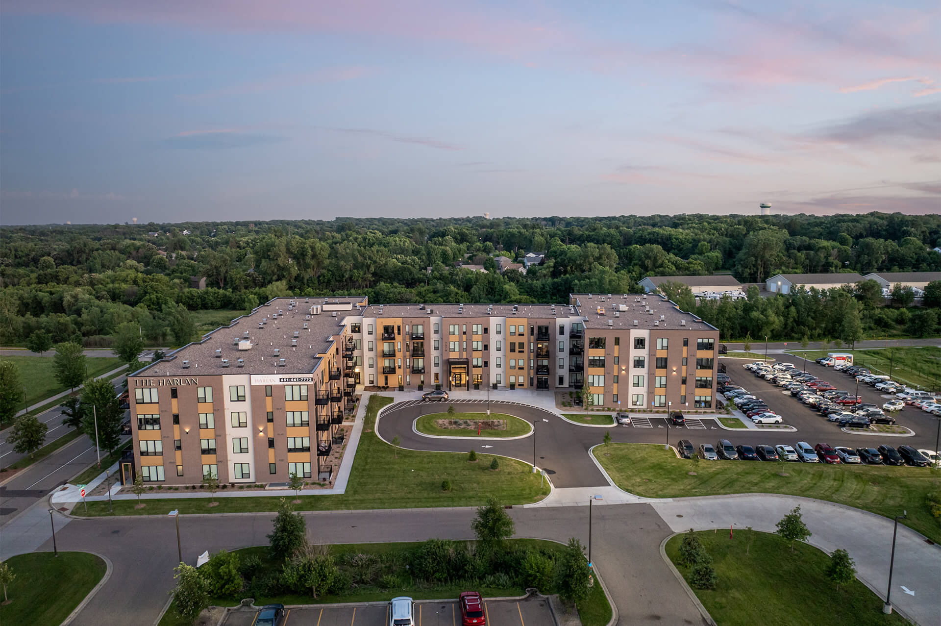 Drone view of The Harlan Oakdale apartment complex and surrounding landscape